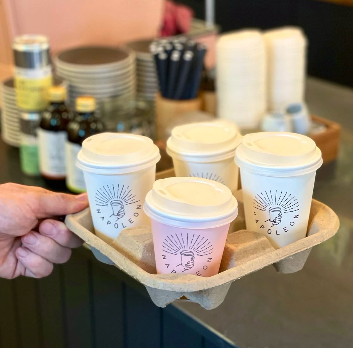 A carry tray of four Napoleon takeaway cups, one in pink